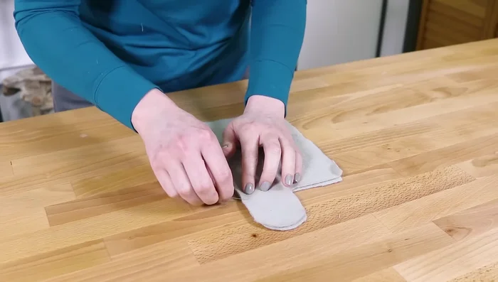 Pin together the upper and lower fleece fronts (right sides facing) so the thumbs line up. Sew across and around the thumb with about an ⅛ inch seam allowance. Backstitch at the beginning and end.