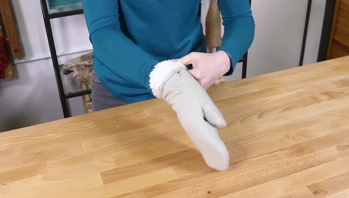 Fold the bottom of the mittens to your desired length. You can tack it with stitches or leave it adjustable for varying weather conditions.