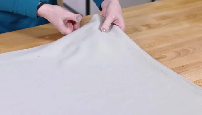 Lay out the fleece (wrong side up), stretch it to determine the stretch direction, and place the pattern pieces accordingly. Trace and cut out the mitten back piece, upper front, and lower front pieces.