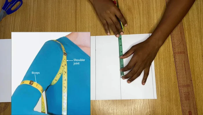 Measure straight from the top point (4 inches in) to the bicep line, divide by two, and mark the midpoint. Connect the top point, midpoint, and bicep point with smooth curves using a French curve or freehand.