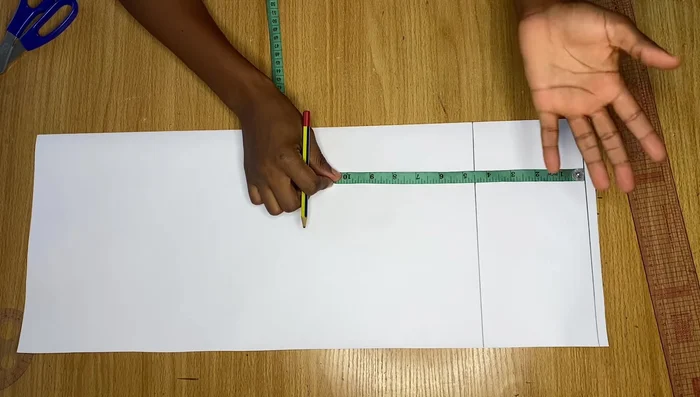 Measure down to the desired sleeve length (e.g., 8 inches for short sleeve). Draw a line across.