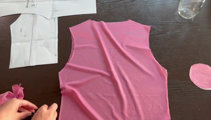 Sew shoulder seams. Align stitch lines, not raw edges. Sandwich ruffle pieces between front and back bodices, aligning notches and raw edges. Sew with a 3/8" seam allowance. Trim excess ruffle fabric.