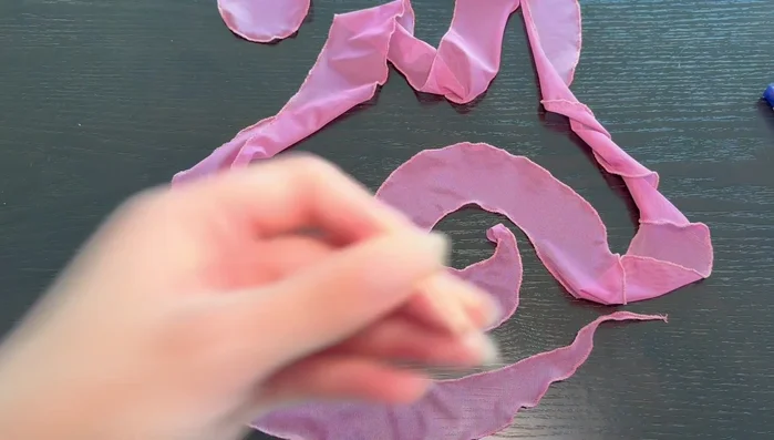 Make the rosette. Use a hand needle and basting stitch along the inner edge of the spiral, gathering as you go. Adjust gathers to achieve desired fullness. Secure gathers with knots after each section.