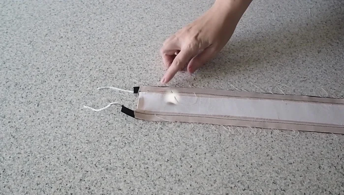 Create triangle shape: Stitch diagonally from one end to the center, then back down to the other side, creating a triangle.