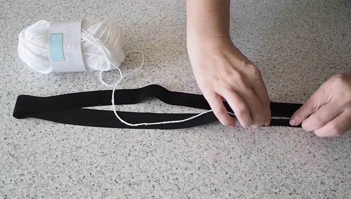 Prepare piping: Cut bias satin viscose fabric, enclose craft cotton twine, and stitch using a piping foot.