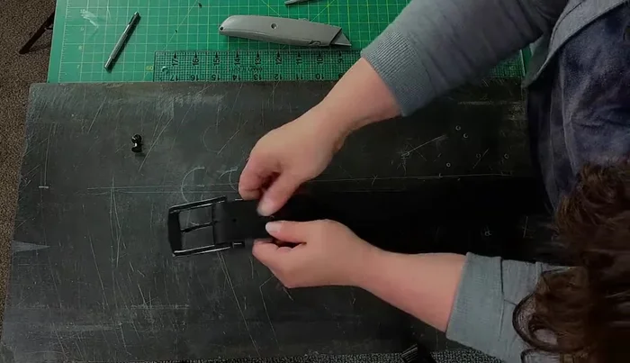 Install the Chicago screws using a mallet to secure the leather around the posts and a screwdriver to tighten them.