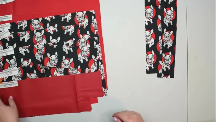 Cut fabric pieces: one pocket trim, one pocket facing, two bottom panels, one loop, two casings, one front, one bag, two zipper pockets, one front lining, and one back lining.