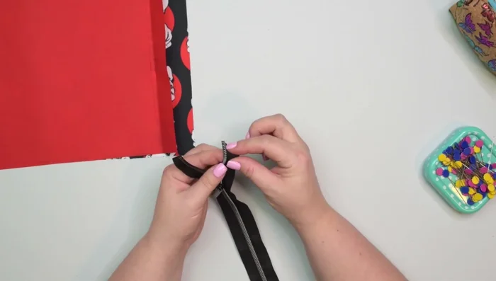 Prepare the zipper: Fold top ends by 90 degrees, pin, baste.