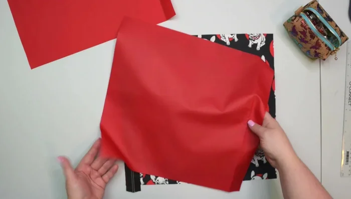 Attach zipper pocket: Align zipper pocket (wrong side facing front) with zipper, clip, sew 7mm seam allowance, press, topstitch.