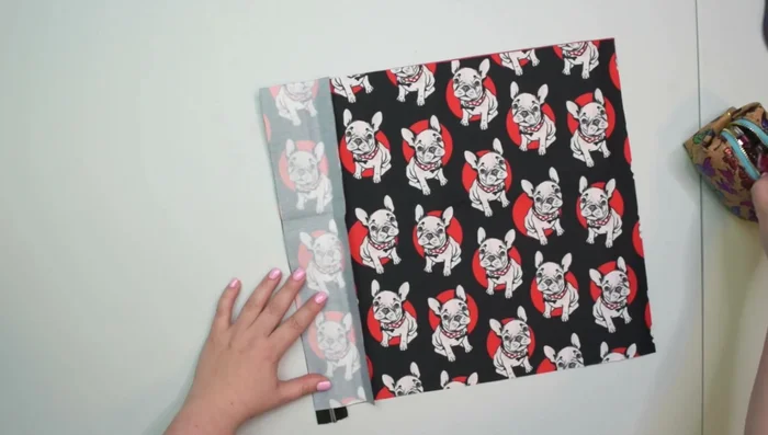 Attach pocket trim: Place pocket trim (right side down) on front, align bottom edges, clip, baste.