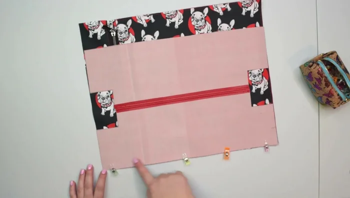 Attach bottom panels to front and back: Attach bottom panels to front and back, sew 1cm seam allowance, press, topstitch.