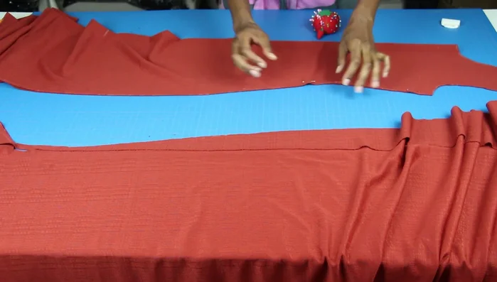 Use the adjusted front piece as a guide for the back piece, ensuring the underarm seams match. Pin and trace the back piece.