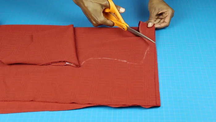 Cut out both the front and back pieces, following your adjusted pattern. Pin and sew the shoulder and side seams together.