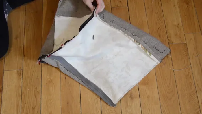 Attach circles to base: Pin one circle to the base opening, matching fabrics and stitching over previous stitches. Open the zipper before attaching the second circle. Hand-sew around the zipper.