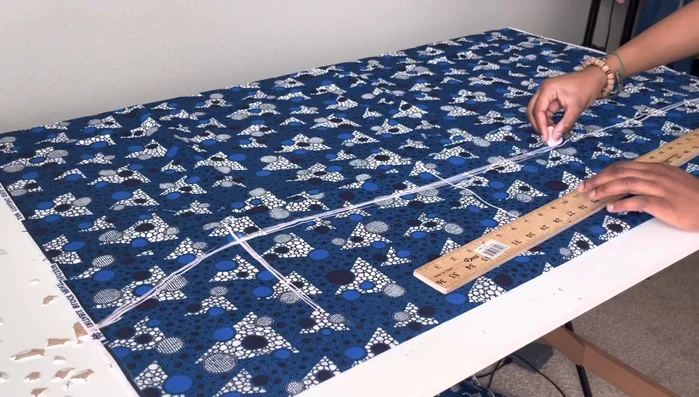 Fold fabric again and cut out the back piece, adding extra width for zipper allowance and a dart for shaping.