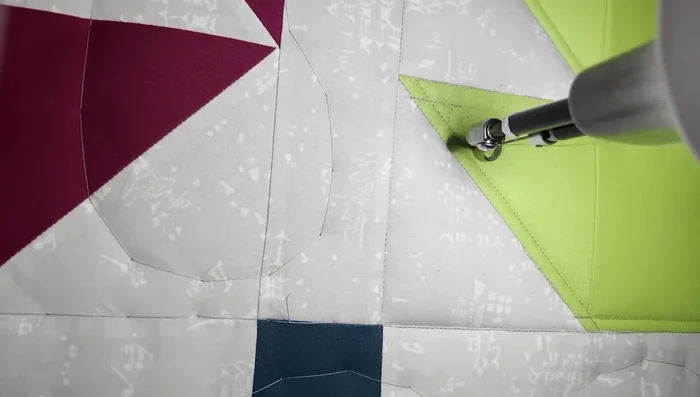 Free motion quilting (inner block): Fill the inside of the maple leaf with swirls. Use a calming, circular motion to create a consistent pattern. Echo the swirls for smaller areas.