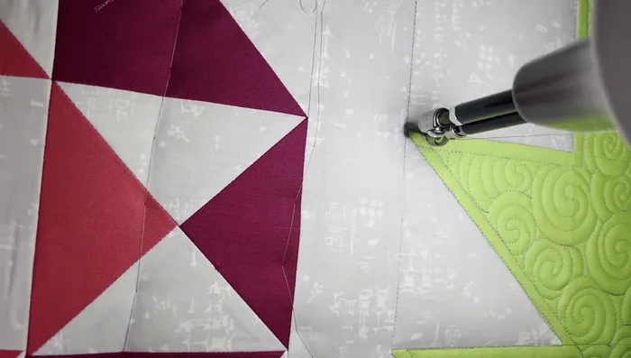 Free motion quilting (background): Fill the background with "smoky swirls" - partial S-shapes with pointed centers, repeated and echoed to fill the space. This creates a contrasting texture to the leaf’s swirls.