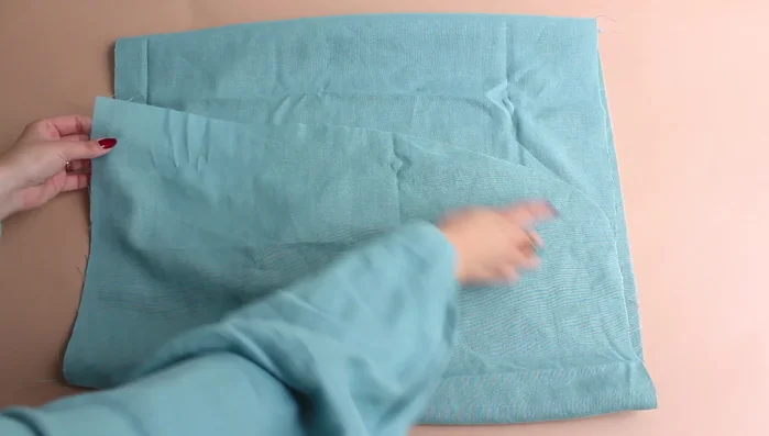 Fold the hem by one centimeter and topstitch