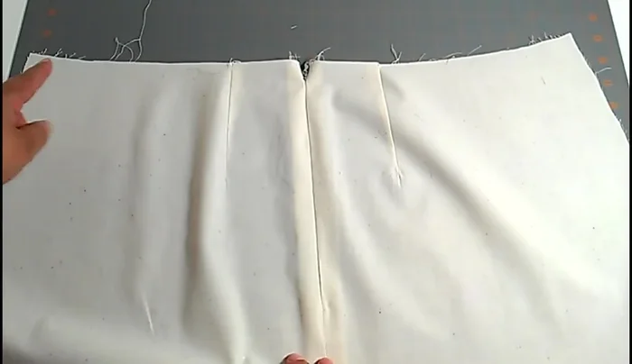 Prepare your lining: Leave a center back opening 1 inch longer than the zipper (e.g., 8 inches for a 7-inch zipper). Finish the seam allowances (same allowance as the skirt).