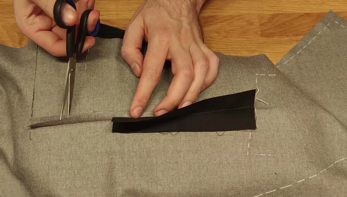 Press open. Trim the top layer to make it slightly narrower than the bottom one, cutting at an angle towards the dart point.