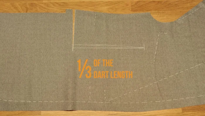 Cut about 1/3 of the dart length. Fold it in half with the base outside the chalk line for basting.