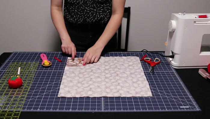 Stitch a 1/4 inch seam around three sides of the outside fabric, securing loops.