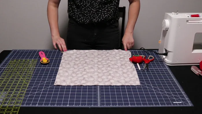 Stitch a 1/4 inch seam around three sides of the outside fabric, securing loops.