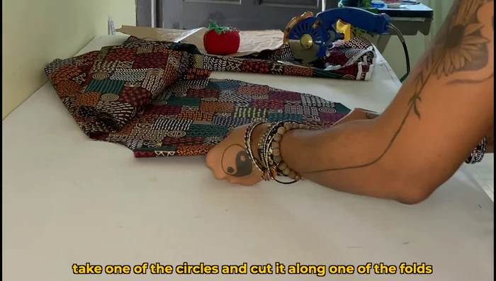 Cut one large circle down one fold to create the front piece.