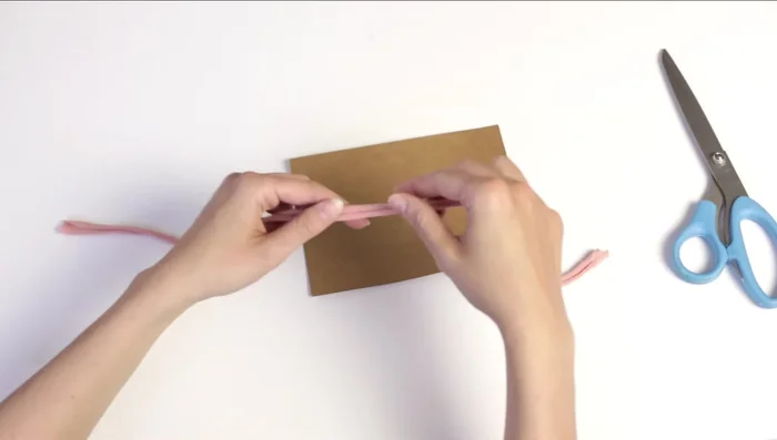 Tie the headband to cardstock (optional) for easier handling.