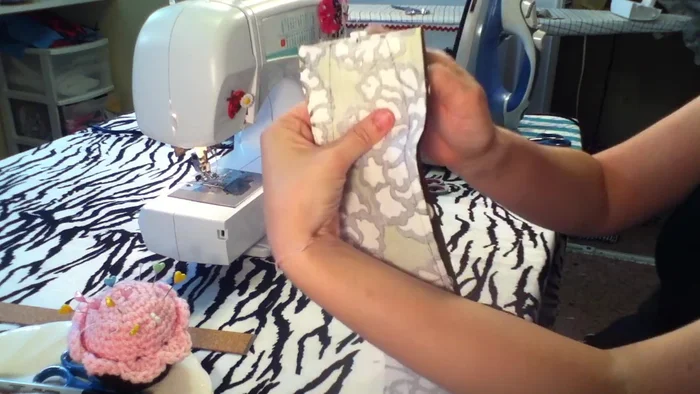 Fold over a 1/4 inch seam allowance on one end for a neat finish and iron it.