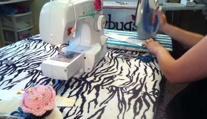 Fold over a 1/4 inch seam allowance on one end for a neat finish and iron it.