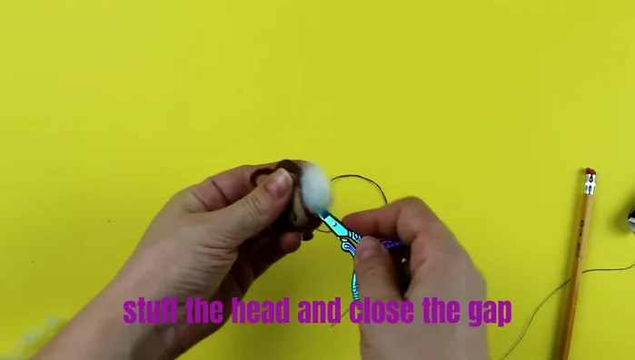 Close the gap in the headpiece using a sewing needle.