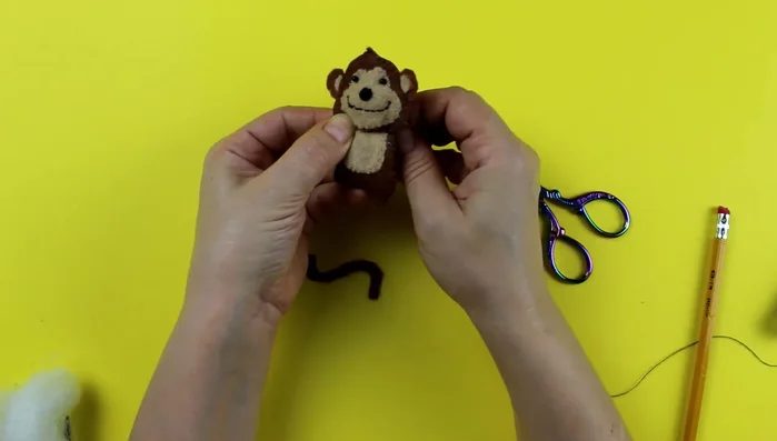 Attach the head to the body using a sewing needle. Match the stitches to prevent a visible seam.