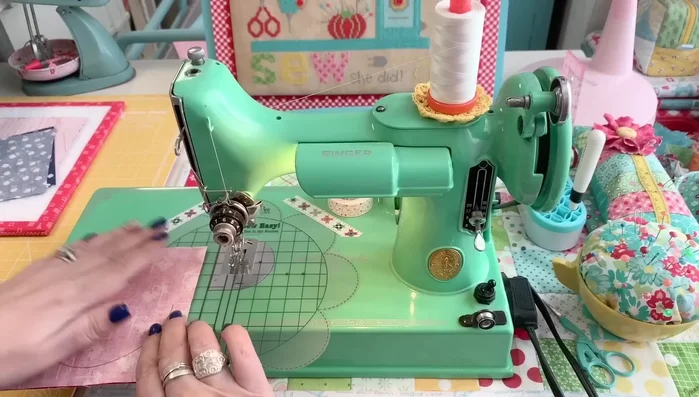 Sew Scallops: Sew each pair of fabric squares together along the marked half-circle, using a 1/2 inch seam allowance. Use an open-toe foot for better visibility.