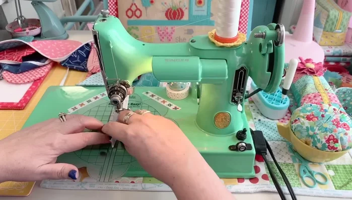 Finish the ends: Fold under the raw edges of the bias tape and sew them down.