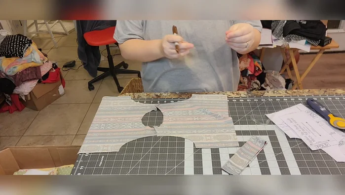 Sew the elastic to the armholes using a serger or a sewing machine with a quarter-inch seam allowance. Stretch the elastic slightly to match the curve of the armhole.