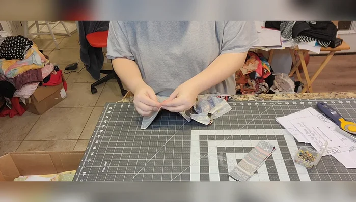 Sew the elastic to the armholes using a serger or a sewing machine with a quarter-inch seam allowance. Stretch the elastic slightly to match the curve of the armhole.