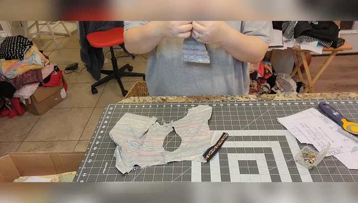 Sew the turtleneck cuff to the neckline, right sides together. Using a serger or sewing machine, match the back seam and shoulder points. Stretch the elastic to fit the neckline.