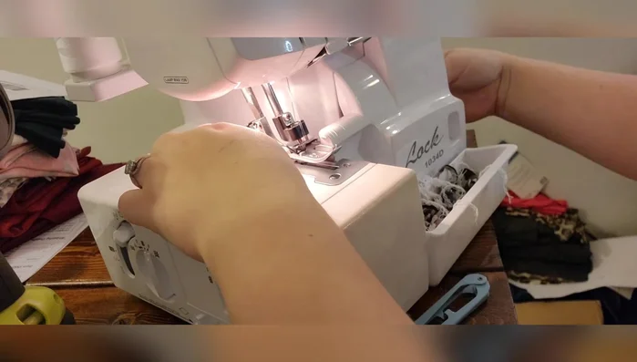 Sew the turtleneck cuff to the neckline, right sides together. Using a serger or sewing machine, match the back seam and shoulder points. Stretch the elastic to fit the neckline.