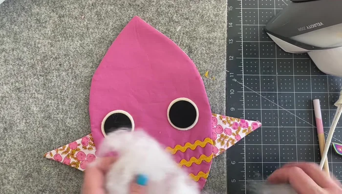 Finish stuffing: Fully stuff the owl.