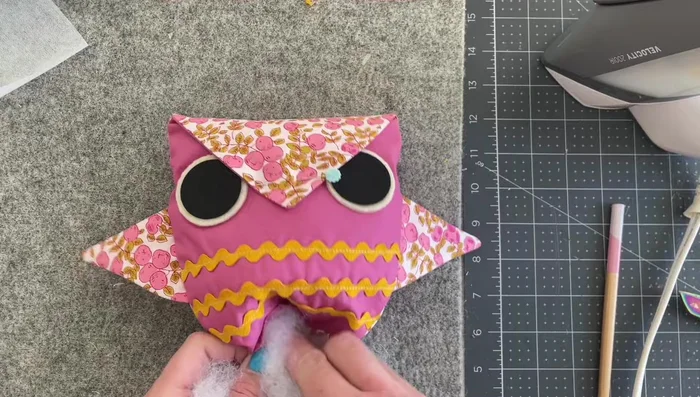 Finish stuffing: Fully stuff the owl.