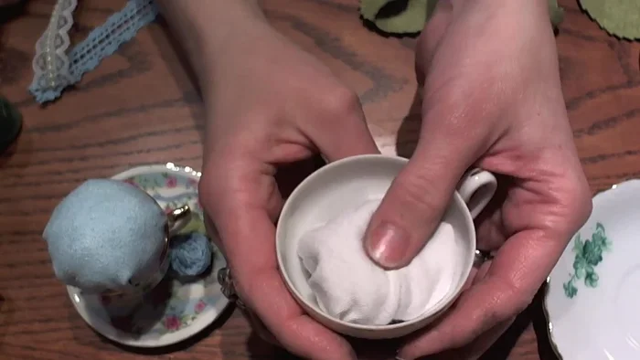 Secure the filling: Using a needle and thread, stitch the edges of the fabric ball together, forming a closed shape. Keep the top even and symmetrical.