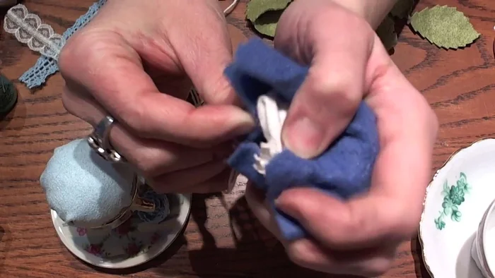 Secure the filling: Using a needle and thread, stitch the edges of the fabric ball together, forming a closed shape. Keep the top even and symmetrical.