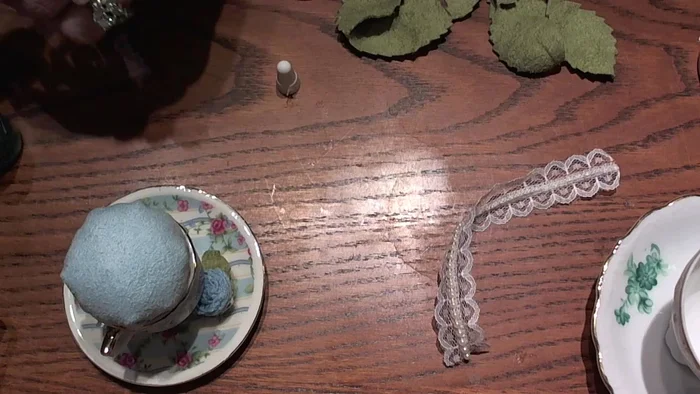 Attach lace: Apply E6000 glue along the top edge where the fabric meets the cup. Carefully press the pearl lace ribbon onto the glue, covering the seam.