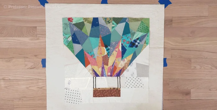 Prepare your materials: Ensure your fabric backing and batting are 4-6 inches larger than your quilt top.