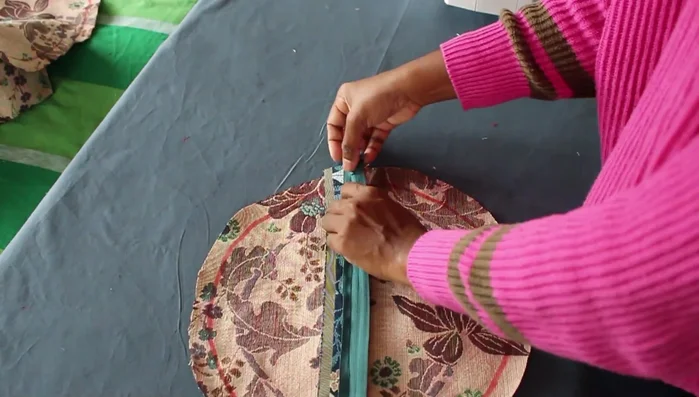 Pin the two circles to the middle part of the cushion and sew together, stitching twice for extra strength.
