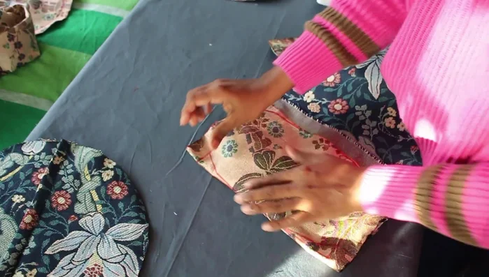 Pin the two circles to the middle part of the cushion and sew together, stitching twice for extra strength.