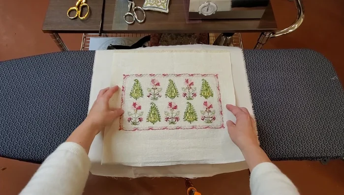 Trim the cushion backing to match the embroidery dimensions.