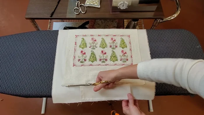 Trim the cushion backing to match the embroidery dimensions.
