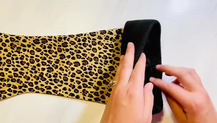 Attach the hanging loop to the back of the stocking, about an inch inside the cuff.